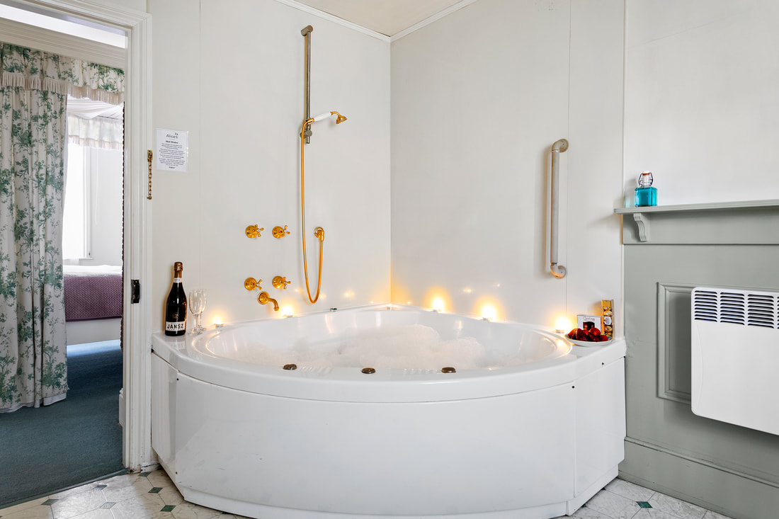 Candlelit spa bath in Irish cottage